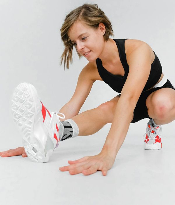 Athletic woman performing dynamic cardio exercises in a modern studio