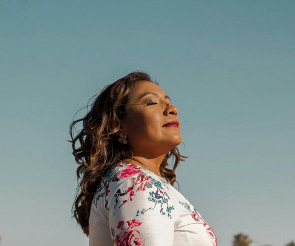 Person breathing deeply in nature during morning exercise